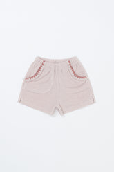 Avauma Pocket Day Shorts in Milk Pink – baby shorts with scallop trim and elastic waistband on white background